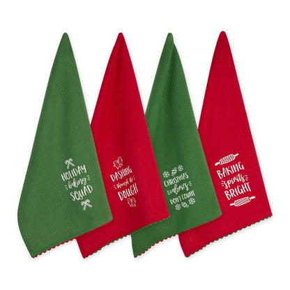 Four Christmas-themed towels in red and green with white text on a white background.