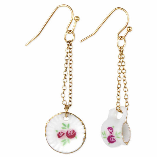 Gold chain earrings with floral designs on a white background